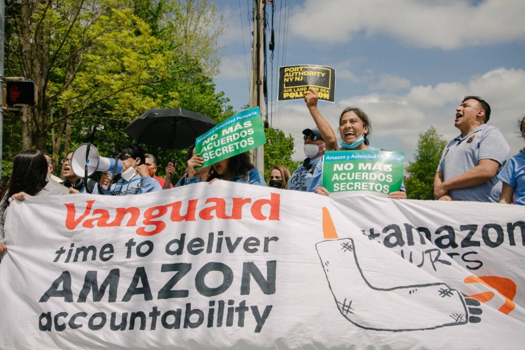Photo of protestors holding a sign that says "Vanguard: time to delivery Amazon accountability"