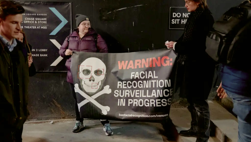 Fans protesting facial recognition outside a John Mayer concert.