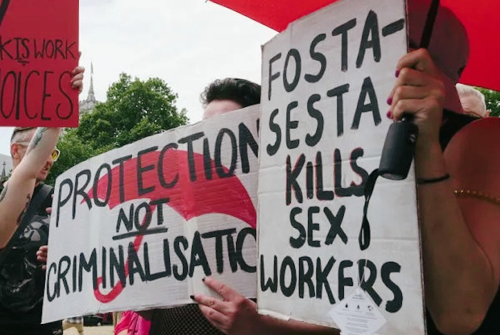 Image of protesters holding signs in opposition to SESTA-FOSTA